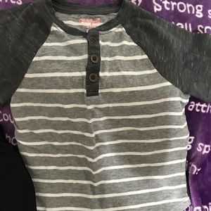 Grey and white shirt and black and red shorts